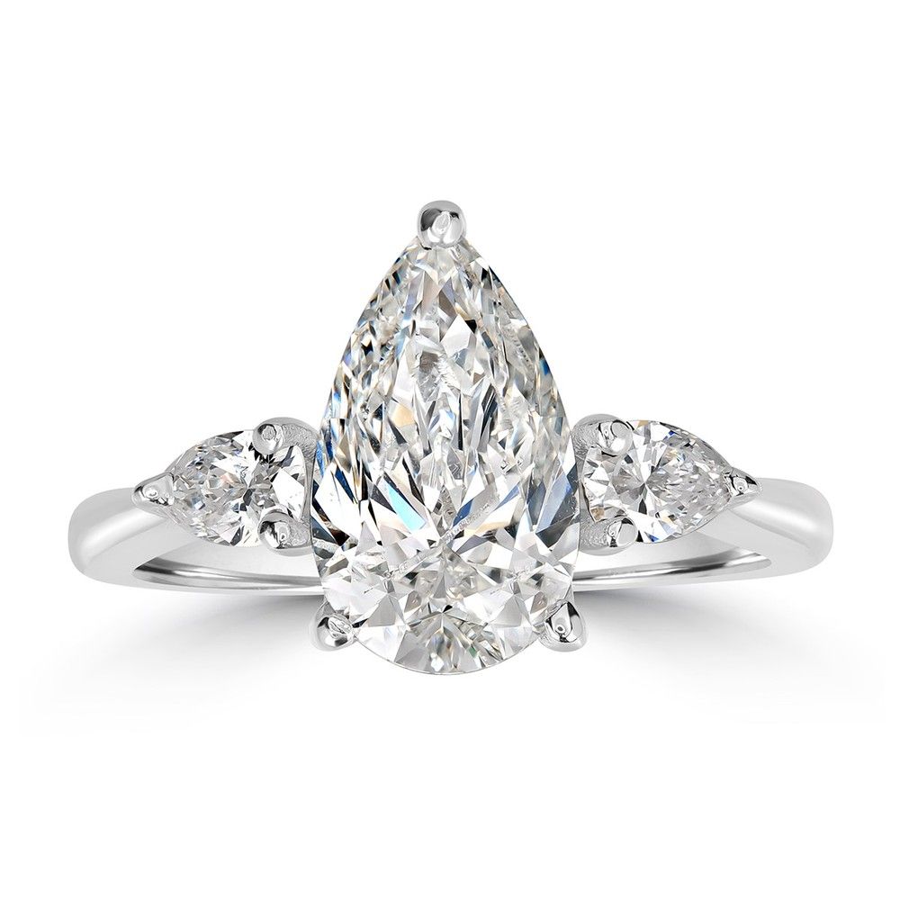 The same pear-cut ring retouched by NeuroViz: clean white background, bright metal, facet edges intact on all three stones