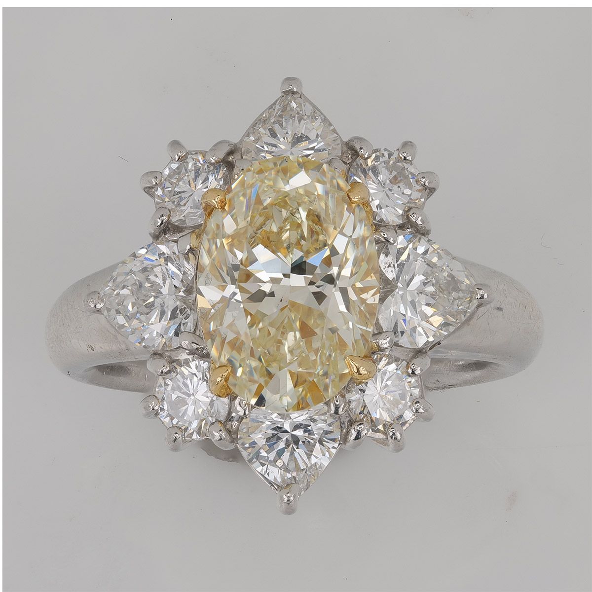 A fancy yellow diamond retouched without color drift — the yellow stays exactly as graded, while the white diamonds around it stay white.